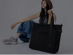 Detail of waterproof nylon tote bag with wide straps and side pocket in urban style