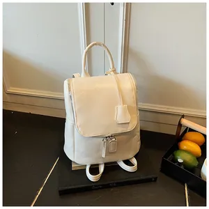 Detail of cream faux leather backpack with pebble grain texture and metal zipper