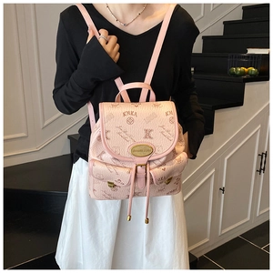 Pink faux leather bucket bag with bear patterns and gold metal logo plaque detail