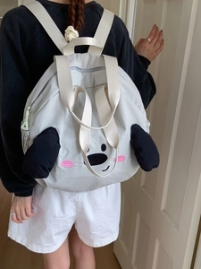 Cute grey nylon backpack with cartoon dog ears and facial embroidery on female model