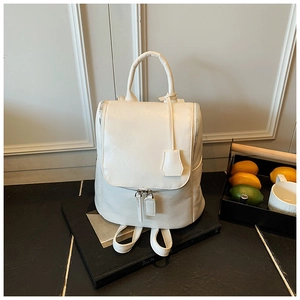 Close-up of creamy white PU leather backpack featuring silver hardware and top handle