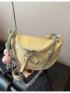 Pale yellow saddle bag with quilted leather, chunky silver chain and colorful charm