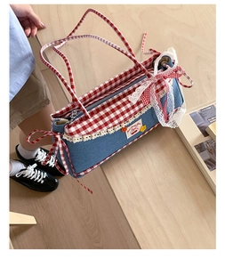 Detail of sweet denim tote bag with cherry patch lace trim and gingham bow accent