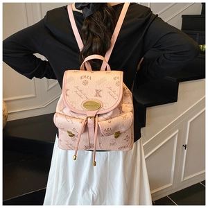 Pink bucket backpack with KMKA logo print and side pockets worn by a model