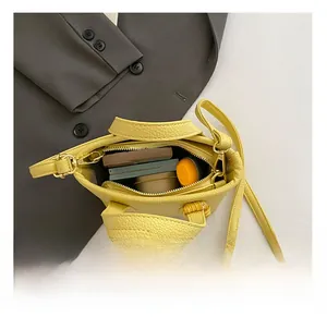 Internal view of yellow pebbled leather bucket bag showing capacity for daily essentials