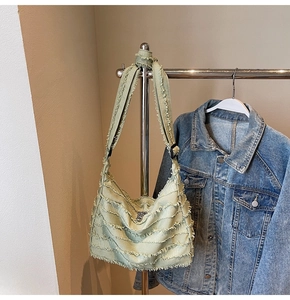 Detail view of light green large canvas tote with layered frayed edge texture