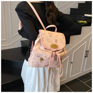 Detail of pink embossed bucket bag with KMKA 1988 monogram and floral patterns