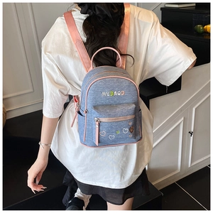 Close-up of denim backpack with MYBAOB colorful letter embroidery and pink straps