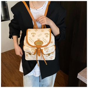 Asian model wearing a retro cream bucket bag with KMKA prints and brown leather trim