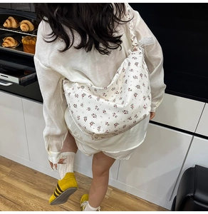 Lace strap floral oxford crossbody bag shown in a cozy home lifestyle setting