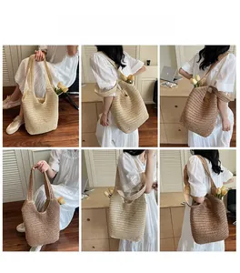Lifestyle view showing woven straw tote bags in beige and coffee colors for summer beach use