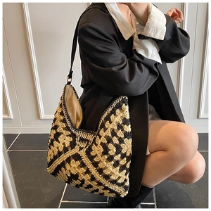 Detail of crochet checkered tote bag with contrast stitching and slim shoulder strap