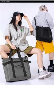 Macro detail of large nylon tote bags in black and gray with tactical webbing straps