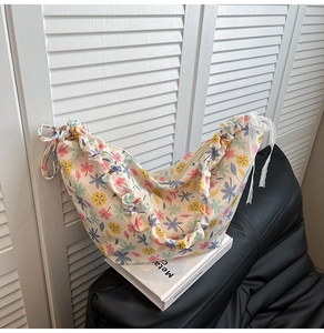 Close-up of floral oxford shoulder bag with ruffle strap and delicate lace side details