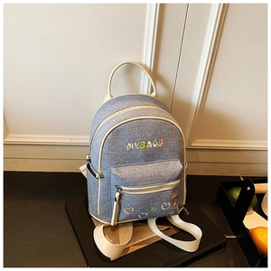 Close-up of color-block denim backpack featuring MYBAOB embroidery and star details