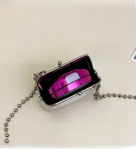 Internal view of mini metal frame bag showing capacity for a powder compact and accessories