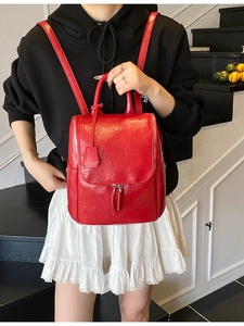 Chic red faux leather backpack with silver zippers and top handle for women