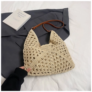 Detail view of handmade beige woven tote bag with brown leather straps and inner lining