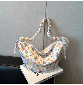 Detail showing white floral canvas bag with ruffled cloud strap and lace trim finish
