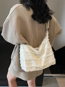 Large white canvas tote bag featuring layered fringe design and wide shoulder strap