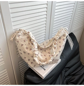 Detail of floral oxford fabric shoulder bag with ruffle texture and lace ribbon decor