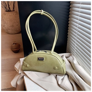 Detail of light green croc-effect crescent bag with elegant metal logo and textured finish