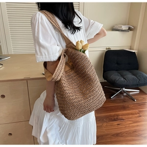 Close-up of the woven texture and spacious interior of the straw shoulder beach tote bag
