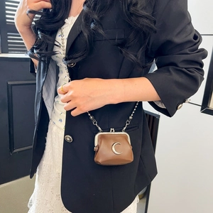Mini brown PU leather crossbody bag with silver moon detail and metal chain strap on model