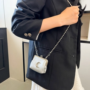 Silver mini moon crossbody bag with beaded chain strap shown on black blazer outfit