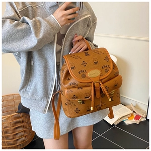 Close-up of brown vintage mini bucket bag with bear print and golden metal buckles