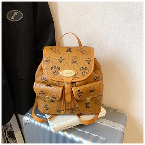 Detailed close-up of brown bucket bag with teddy bear pattern and litchi texture