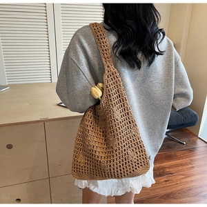 Detailed back view of a brown crochet mesh tote bag featuring a large capacity design