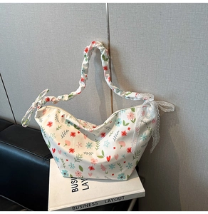 Close-up of floral Oxford bag with heart patterns and ruffled shoulder strap detail