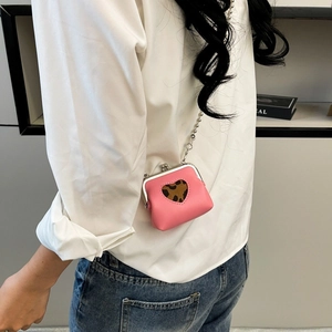 Close-up of pink mini chain bag with heart leopard print and silver metal clasp