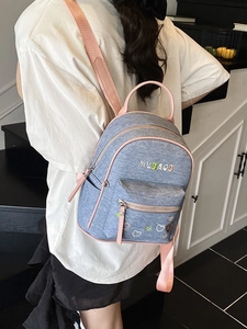 Fashionable denim backpack with pink contrast straps and embroidered heart for women