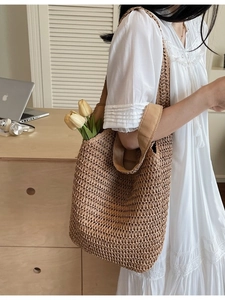 Handmade woven straw shoulder bag for women with durable canvas straps in natural tan