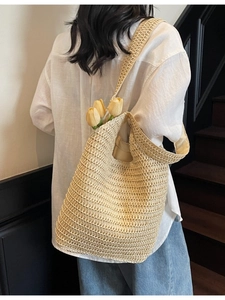 Handmade straw shoulder bag with hollow weave and tulip detail for summer beach travel
