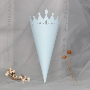 Close-up of light blue hollow crown paper cone for wedding flower petals on soft tulle