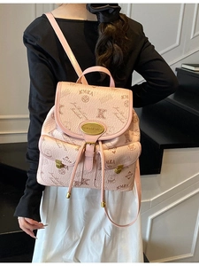 Pink printed bucket backpack with cute bear patterns and metal buckles shown on model
