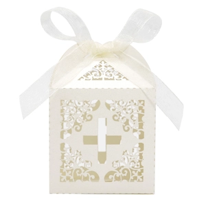 Intricate laser-cut ivory cross favor box with elegant white organza ribbon detail