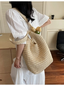 Handmade woven straw tote bag for women featuring a minimalist beige crochet design