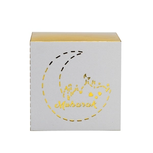 Detail of white and gold Mubarak candy box featuring laser-cut moon and palace patterns