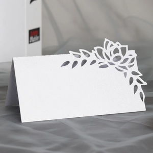 Detailed laser-cut hollow rose design on white pearlescent paper table name card