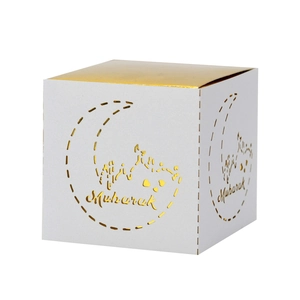 Detail of dark blue Eid Mubarak gift box with gold laser-cut moon and mosque silhouettes