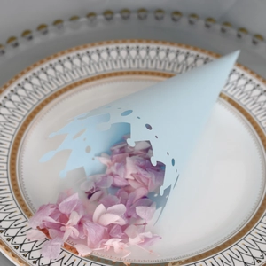 Detail of light blue crown-cut paper flower petal cone filled with dried hydrangea