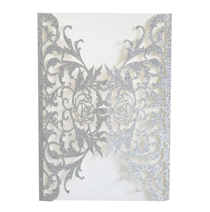 Detailed laser-cut silver glitter wedding invitation cover with intricate floral pattern