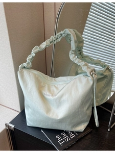 Light green pleated nylon tote bag with happy vibes embroidery and shoulder strap