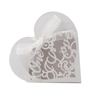 Elegant white laser-cut heart favor box with Love motif and white organza ribbon bow