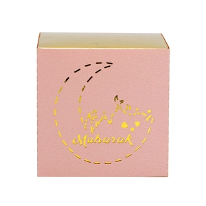 Close-up of pink Eid Mubarak gift box with gold mirror moon and festive lettering