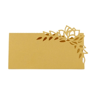 Detailed laser cut champagne gold rose pattern on pearlescent wedding place cards